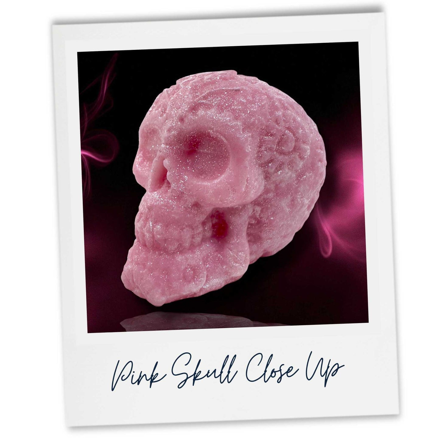 Close-up of a pink wax skull with a dark background