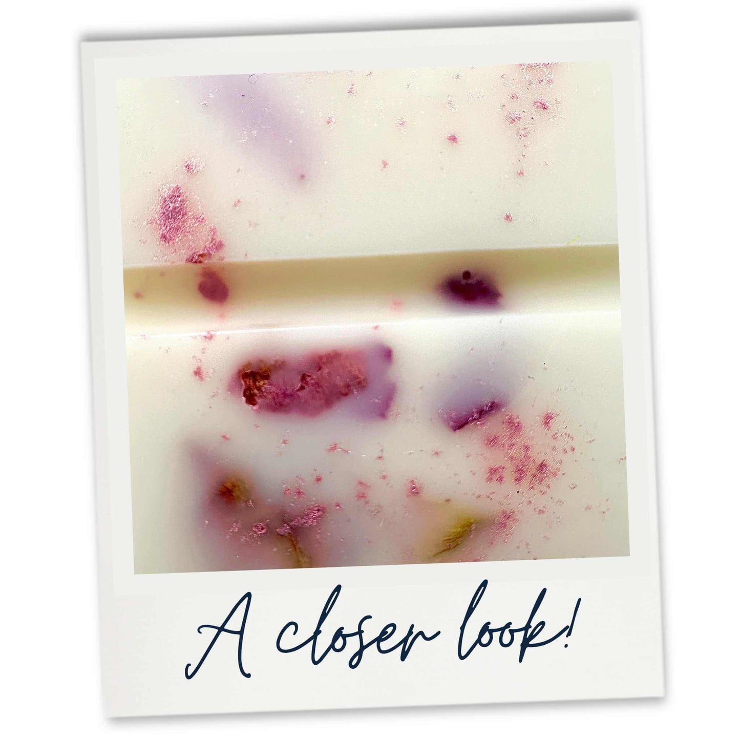 Close-up of Turkish Rose & Mimosa wax melts with pink and purple petals on a white background, labeled 'A closer look!'.
