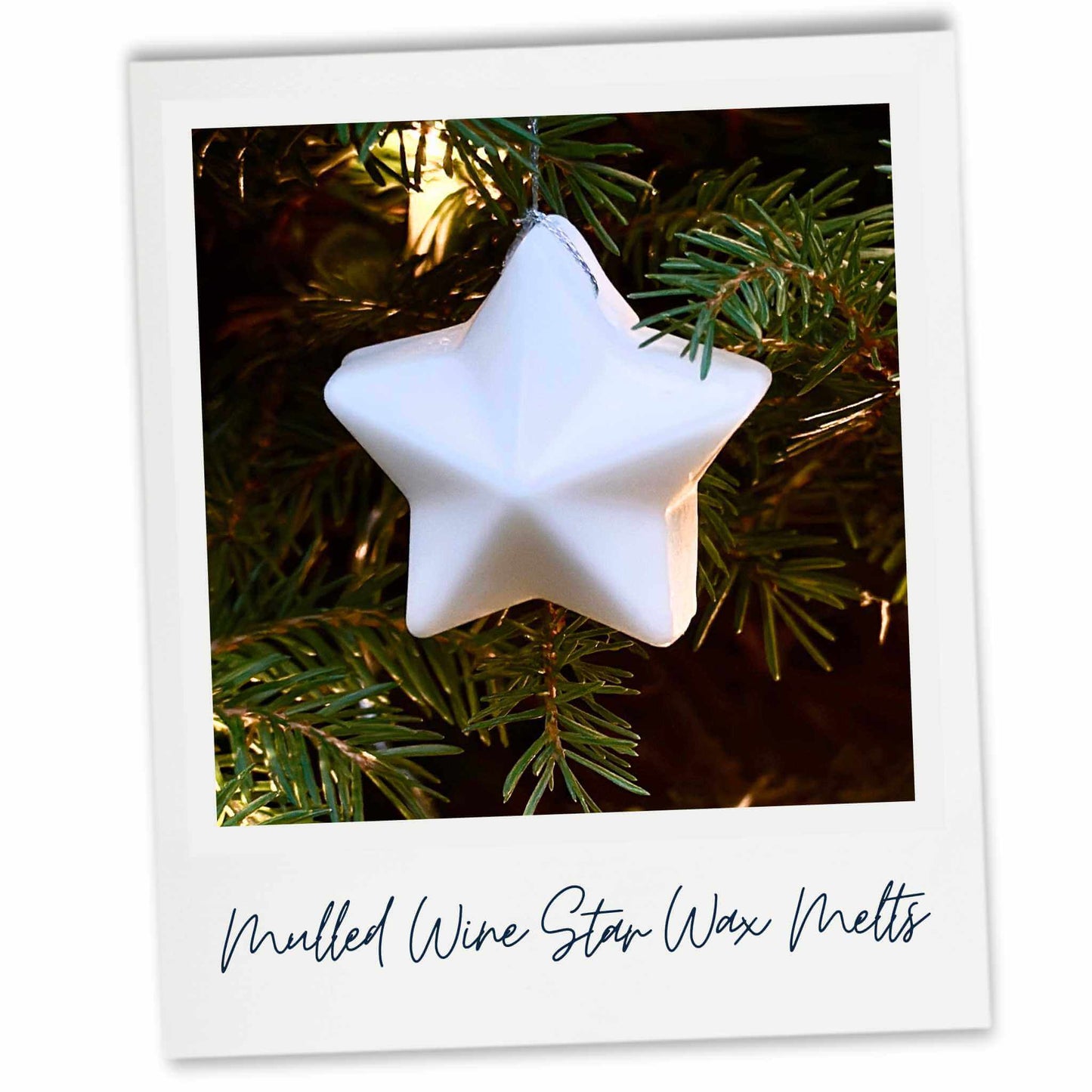 White coloured star-shaped hanging wax melt on a Christmas tree.