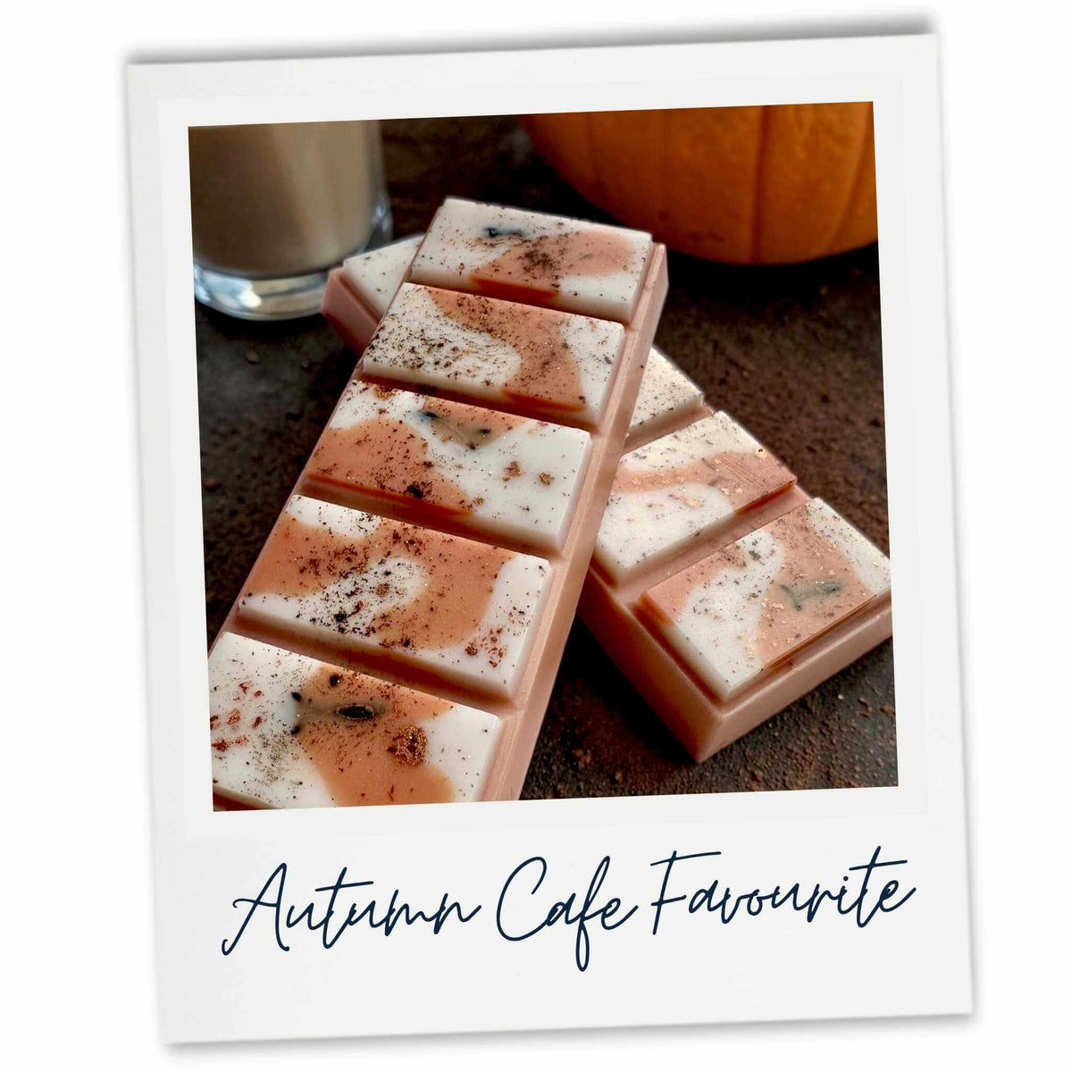 A Polaroid-style photoshowing two coffee latte wax melts with a marbled caramel, white and brown pattern, sprinkled with dark spice. The text 'Autumn Cafe Favourite' is written below on a white border.