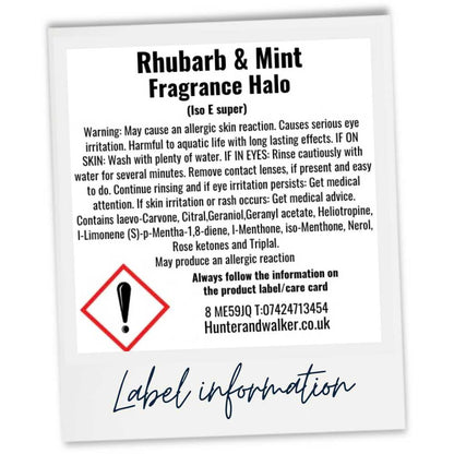 A white rectangular CLP product label card for 'Rhubarb & Mint Fragrance Halo' with black text, a red warning symbol, and handwritten blue text reading 'Label information' below, shown on a white background.