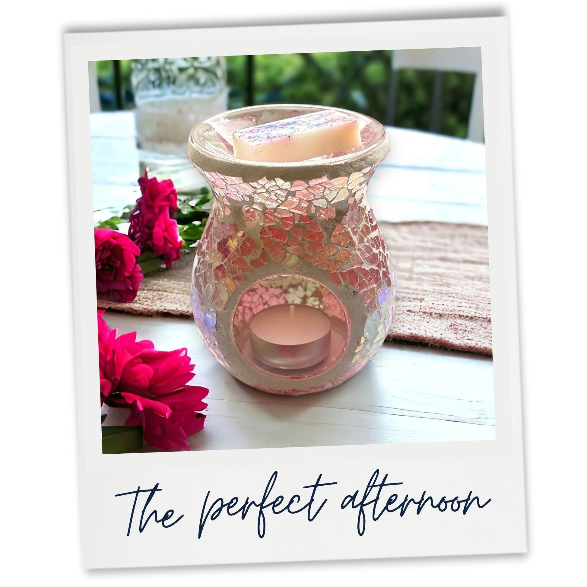 Pink mosaic wax warmer on a patio table outdoors.